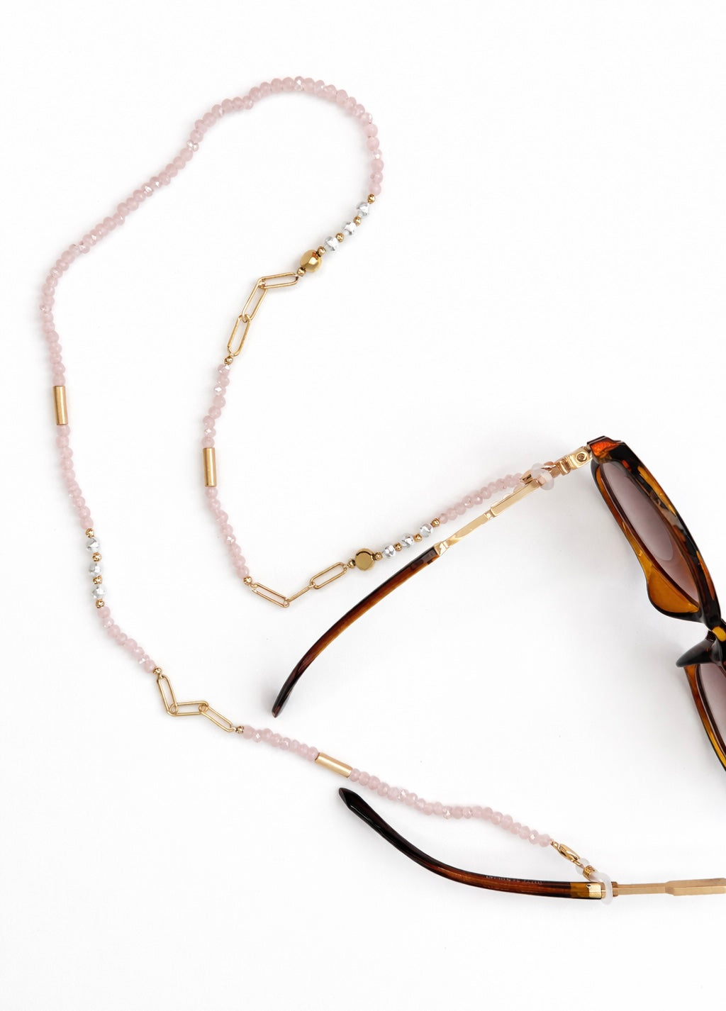 Sunglasses with a beaded eyewear holder on a white background