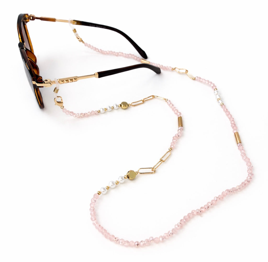 Sunglasses with a pink beaded eyeglass holder on a white background