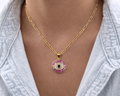 Gold pink evil eye pendant on model