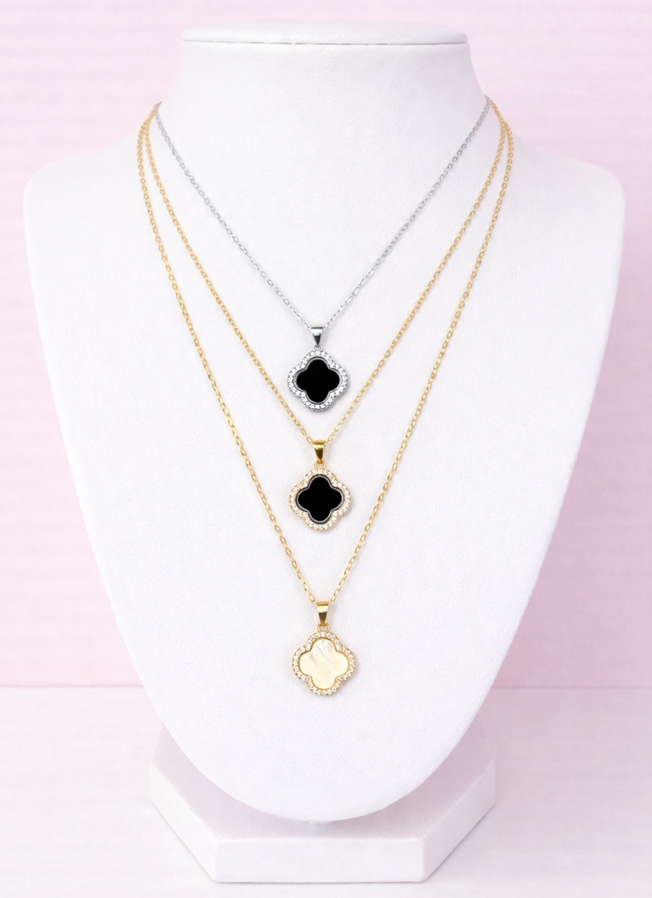 Three gold clover necklaces
