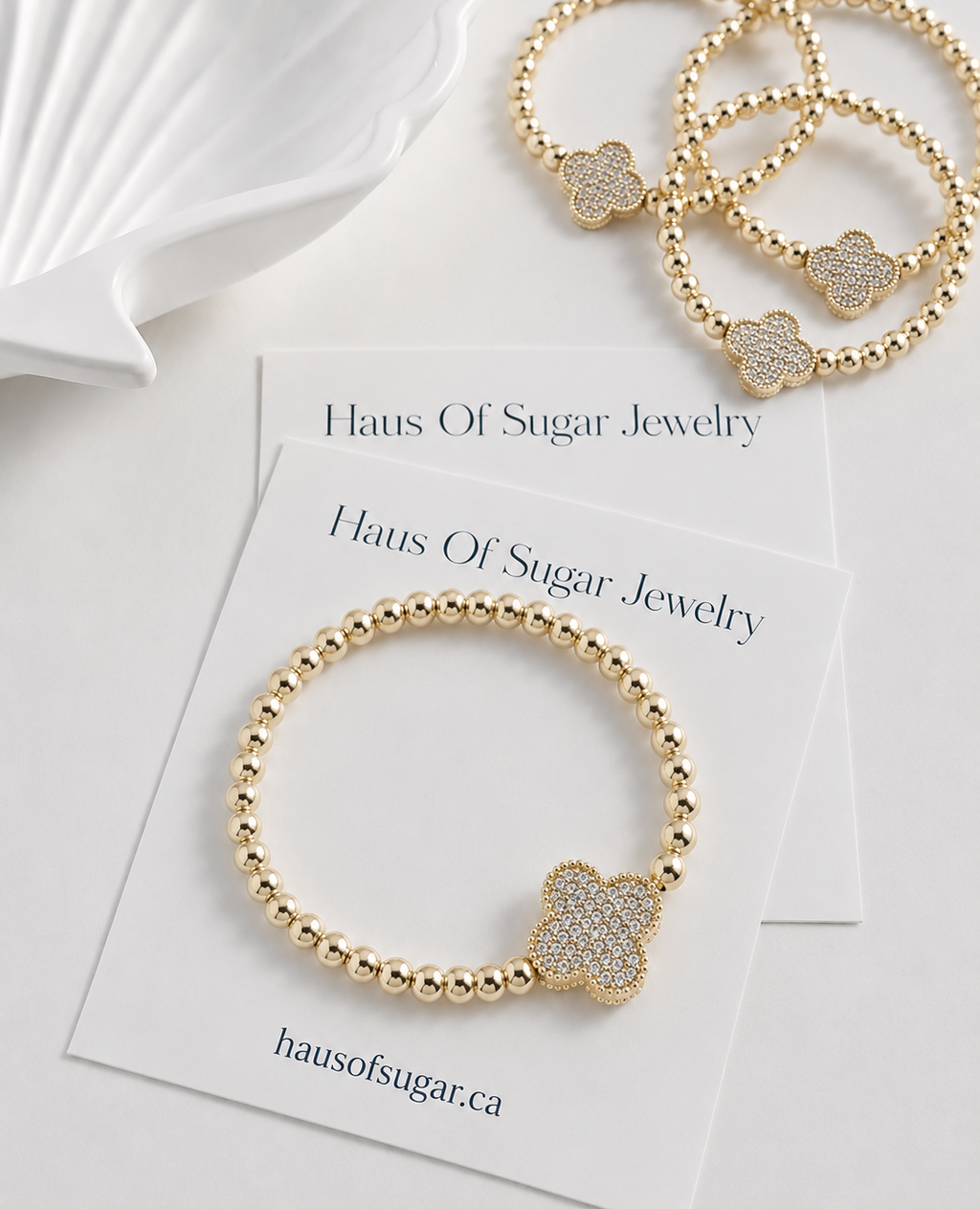 14k Gold plated beaded stretch bracelet with a clover-shaped charm