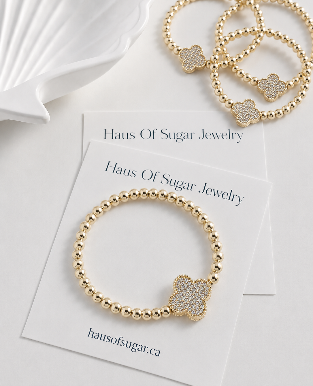 14k Gold plated beaded stretch bracelet with a clover-shaped charm