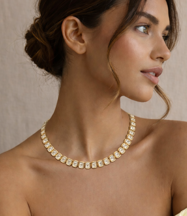 Model wearing gold tennis style necklace