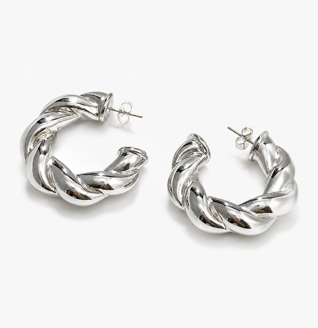 Silver twisted hoop earrings with a chunky rope-inspired design on a white background.