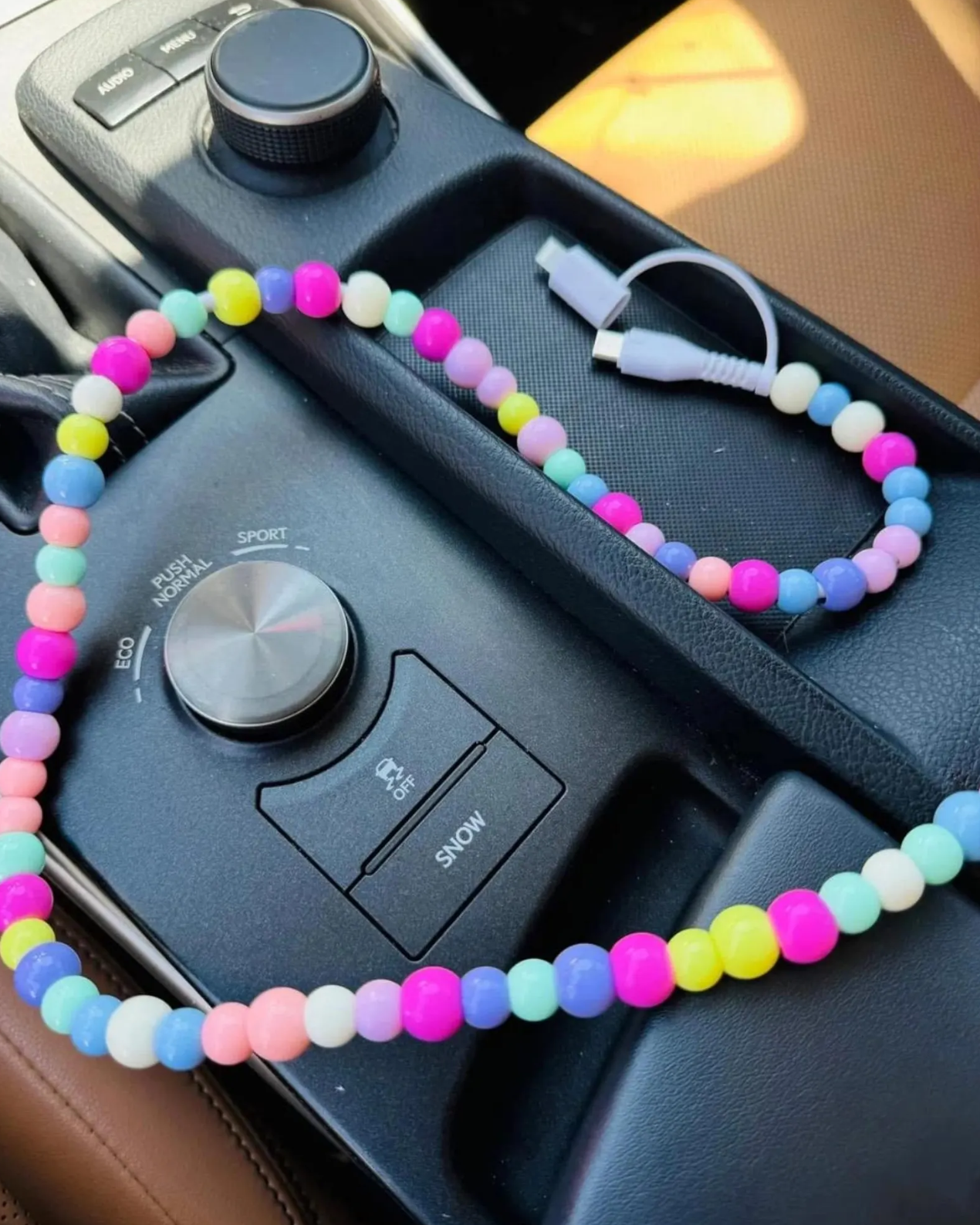 Colorful beaded charging cable with USB connector and 2-in-1 Type-C and Lightning ends on white background