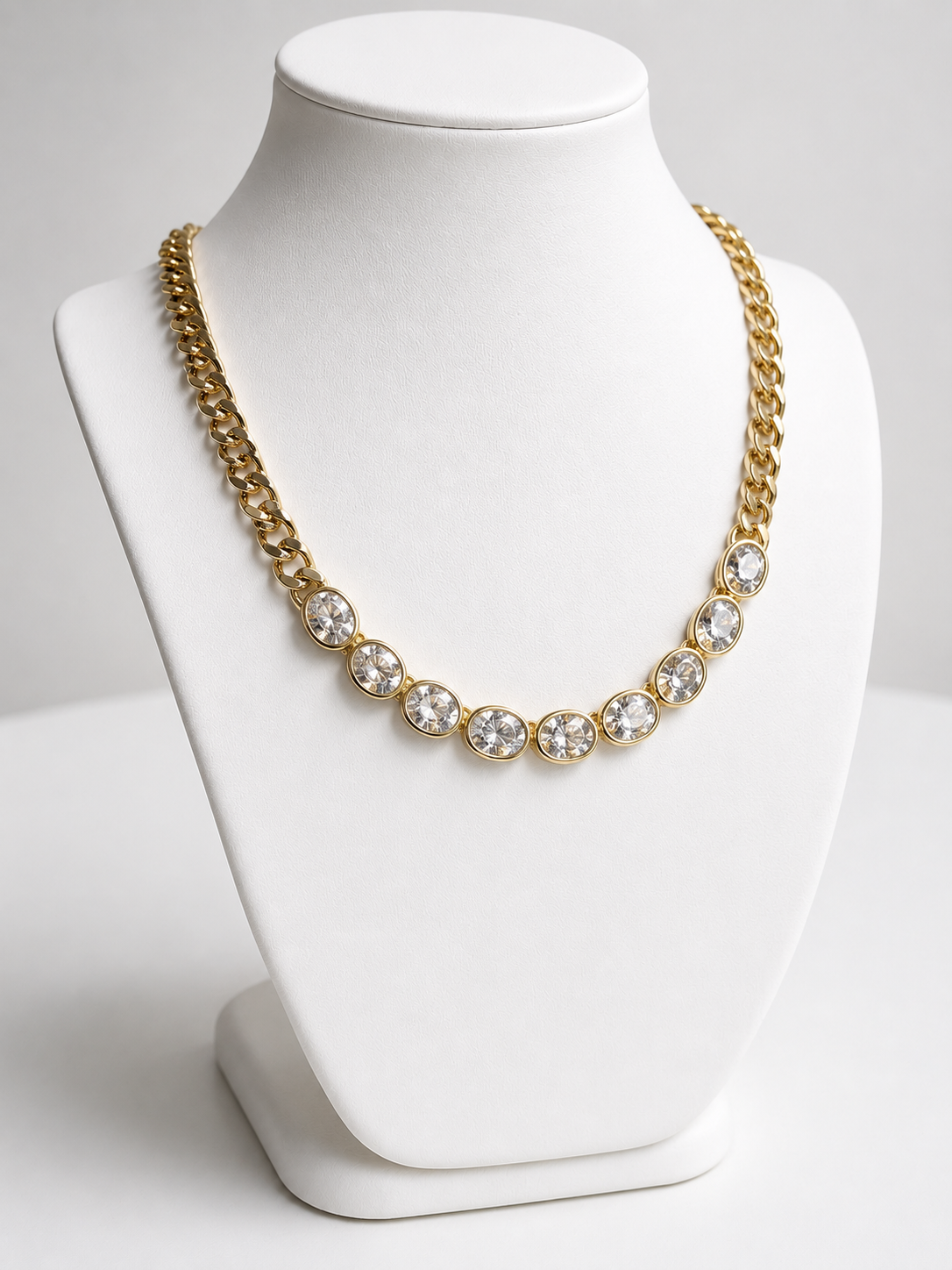 Dakota Necklace in 14k gold plating featuring oval cubic zirconia stones on a chunky cable link chain shown on display