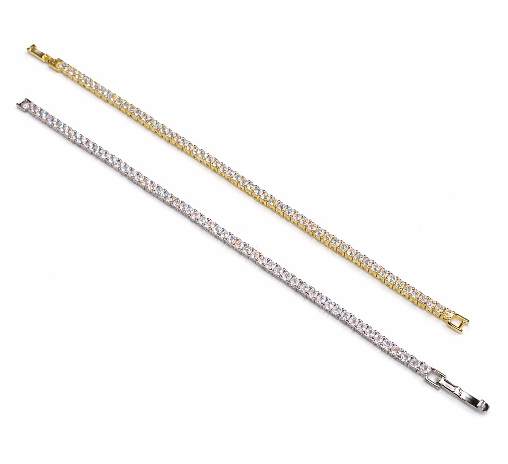 Two diamond tennis bracelets, one gold and one silver, on a white background.