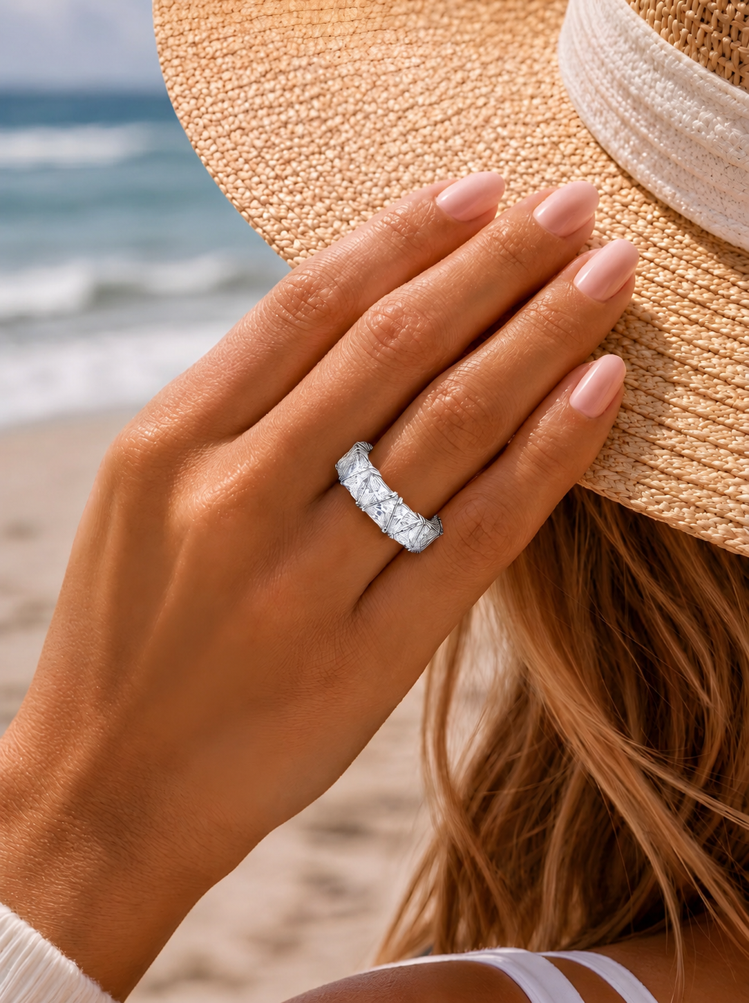 Model wearing the Maya Ring, a silver-tone eternity ring with sparkling triangular-cut clear stones.