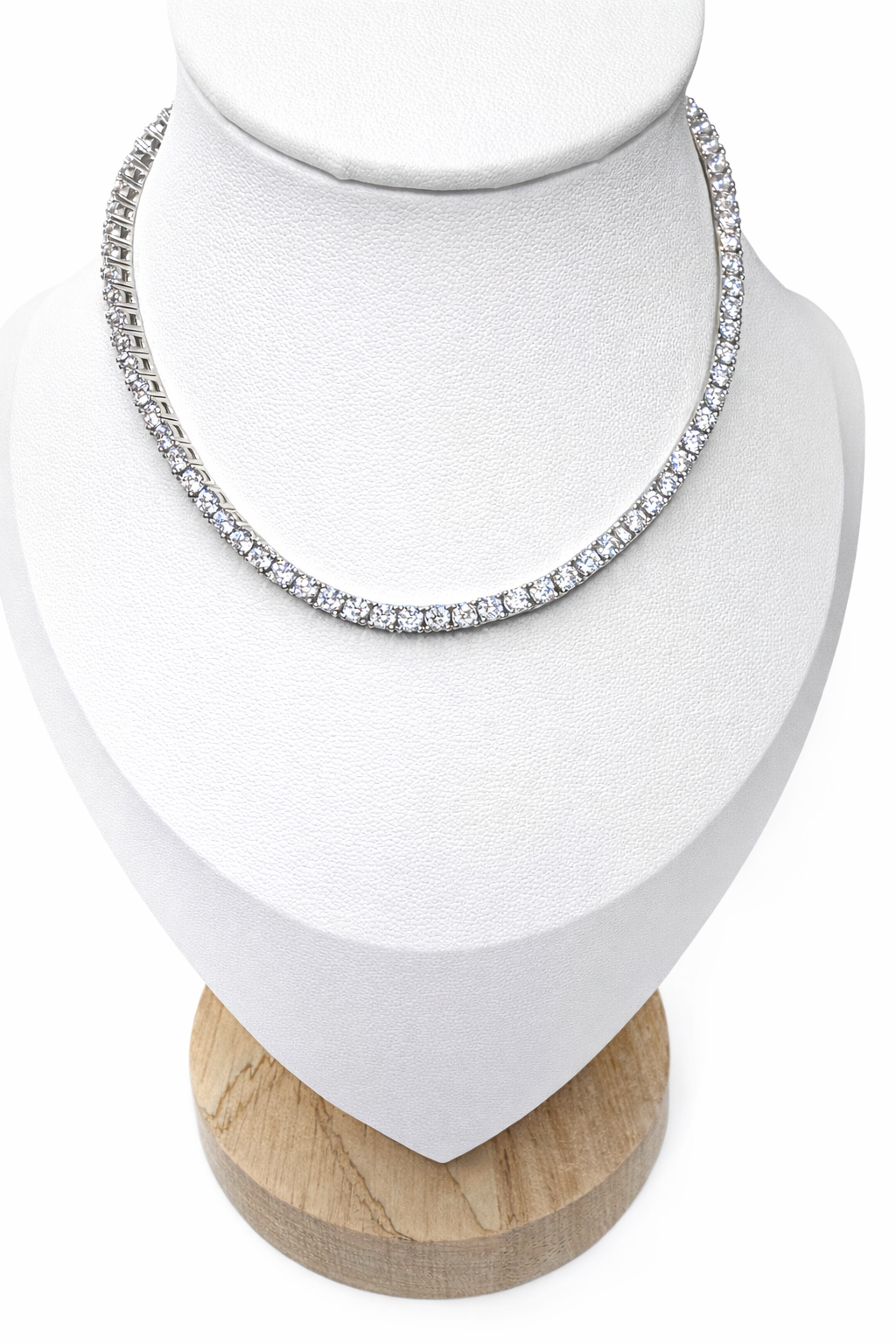 Silver tennis necklace on a white bust