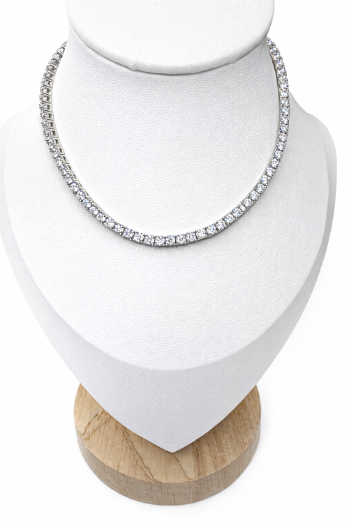 Silver tennis necklace on a white bust