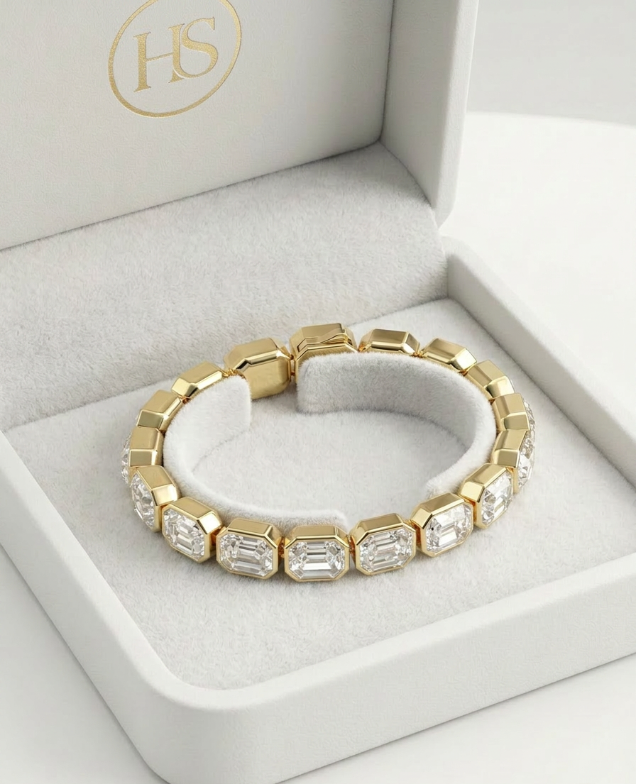 Close-up of gold bracelet with clear rectangular crystals catching light