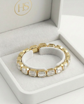 Close-up of gold bracelet with clear rectangular crystals catching light