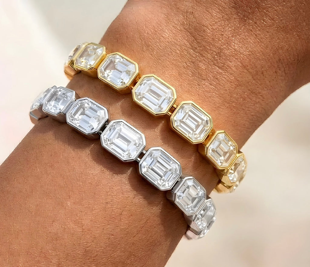 Close-up of gold and silver bracelet with clear rectangular crystals catching light
