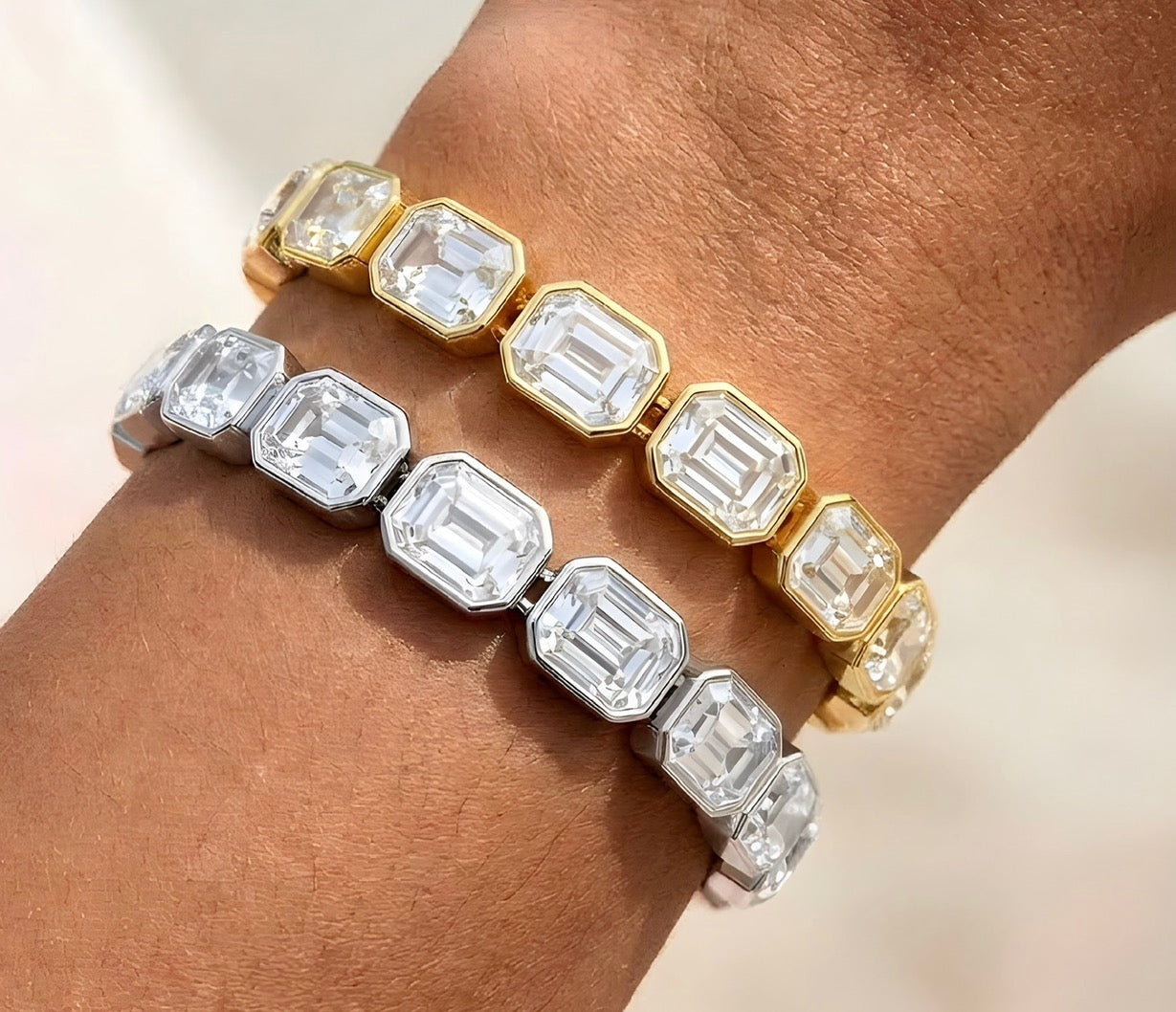 Close-up of gold and silver bracelet with clear rectangular crystals catching light