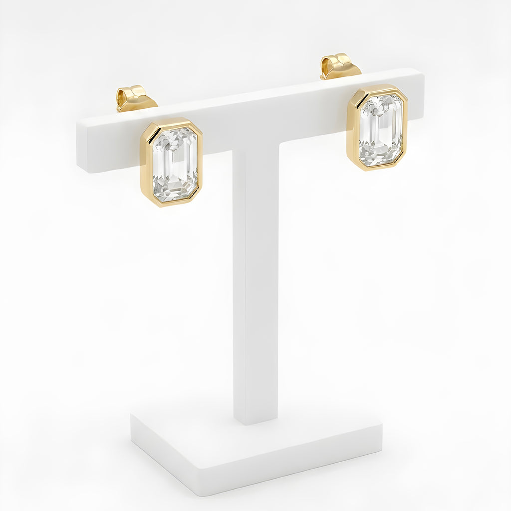 Gold octagon crystal stud earrings on white display stand