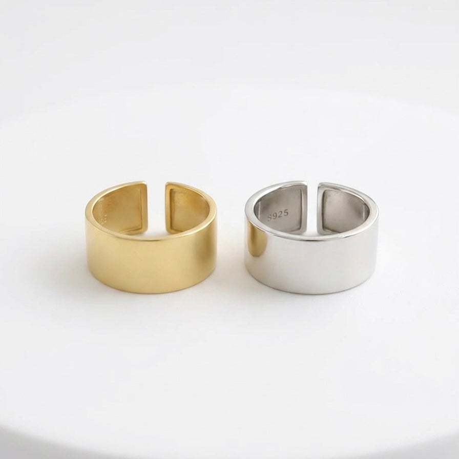 Close-up of gold wide band ring cuff polished mirror-like finish.