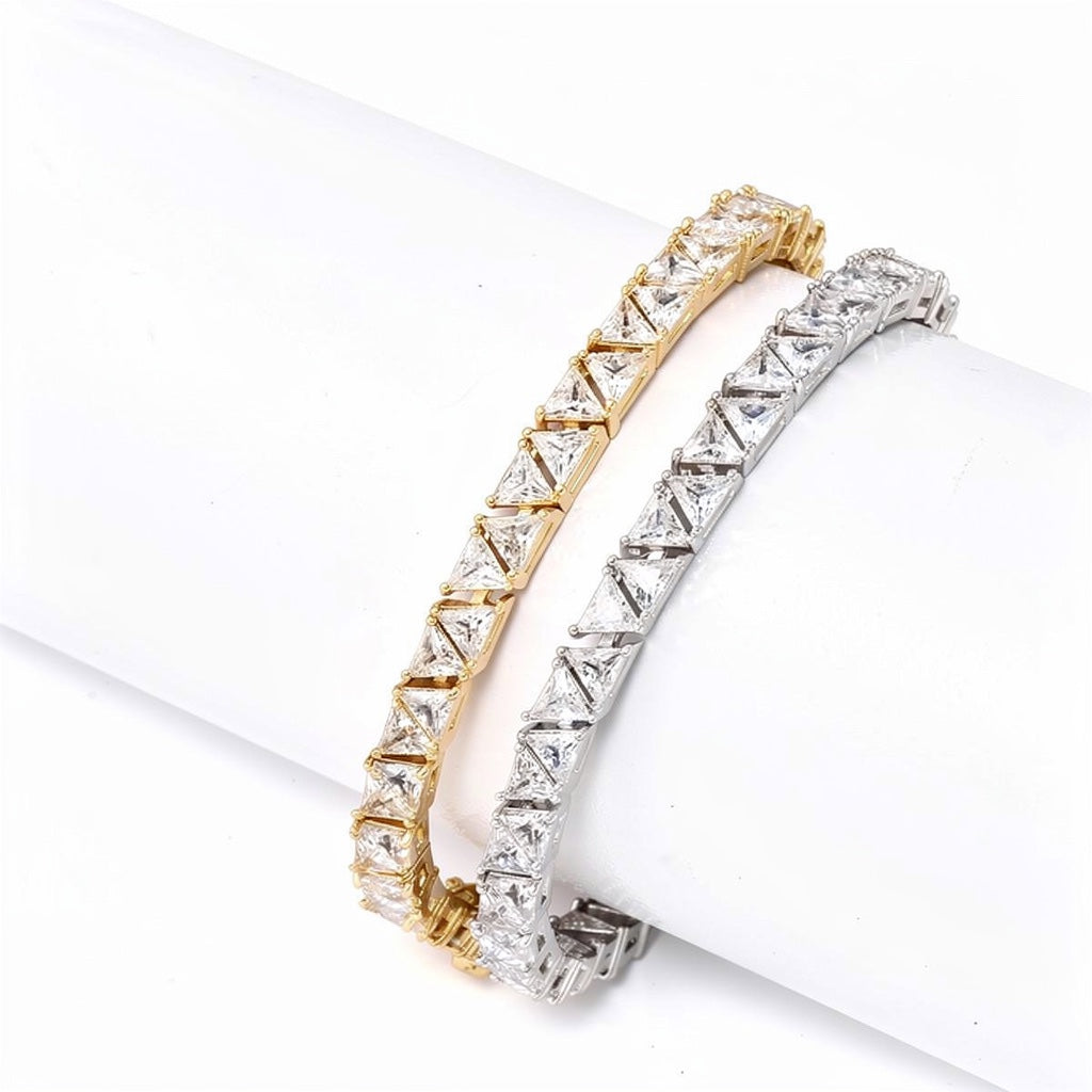 Gold and rhodium geometric tennis bracelets worn stacked on display