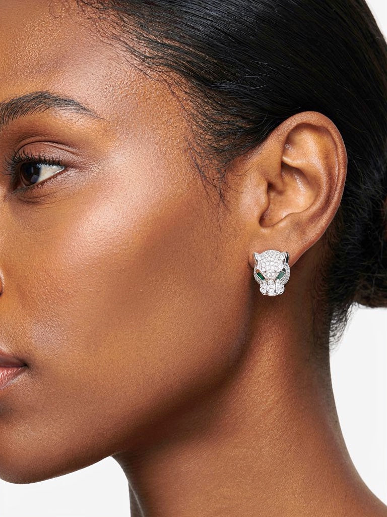 Model wearing silver leopard head stud earrings