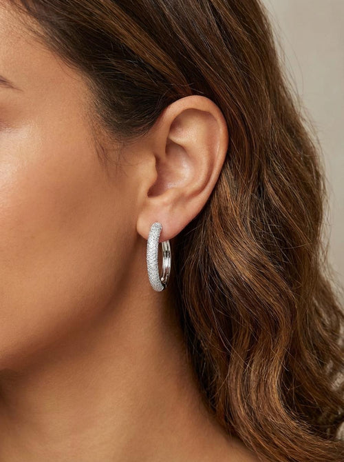Model wearing small sterling silver, pavé hoop earrings