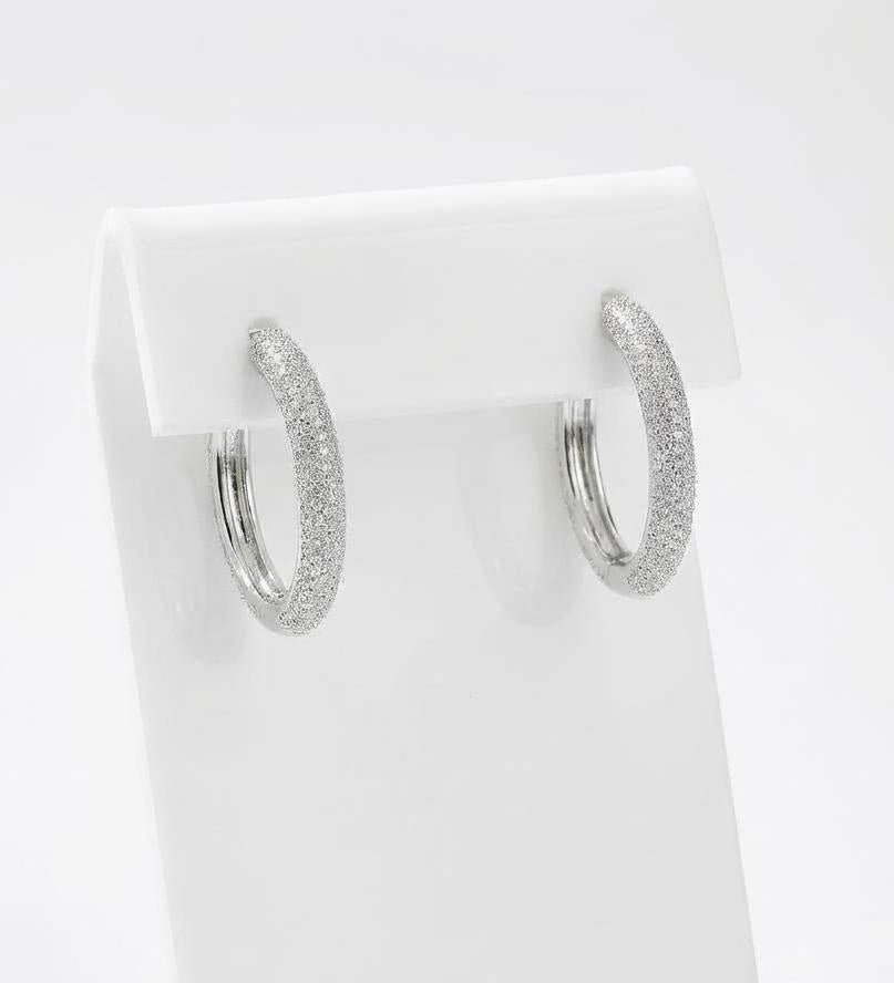 Sterling silver pavé hoop earrings, displayed on white jewellery stand