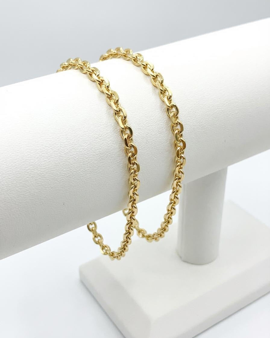 Gold plated, oval cable chain bracelet, displayed on white jewellery stand