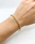 Gold, oval cable chain bracelet, worn on wrist