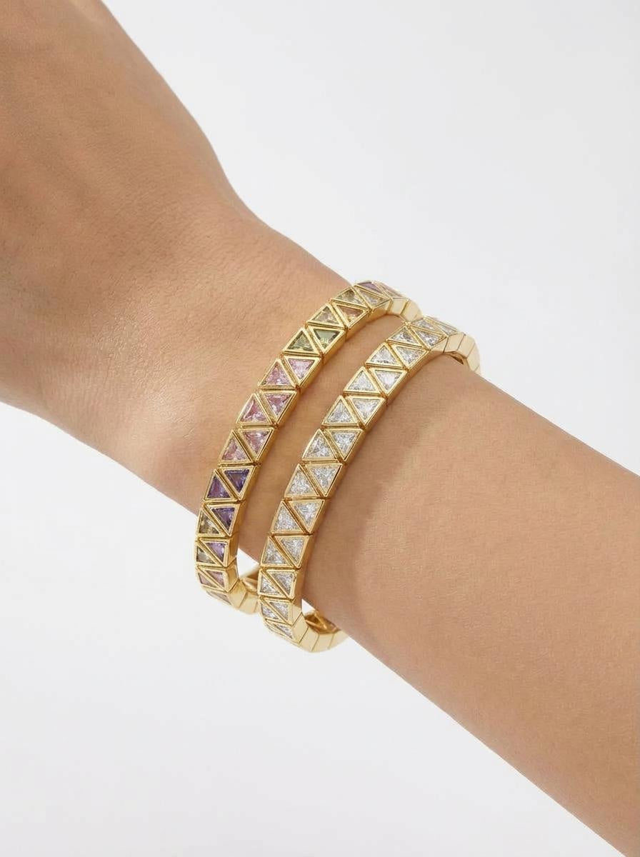 Gold stretch bracelet with triangular cubic zirconia stones worn on wrist, minimalist jewellery styling