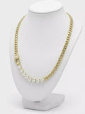 Gold-plated curb link necklace with row of clear cubic zirconia stones on display bust