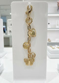 Rhodium tone, charms displayed on a jewelry, stand with heart, smile face, peace symbol, and butterfly accent