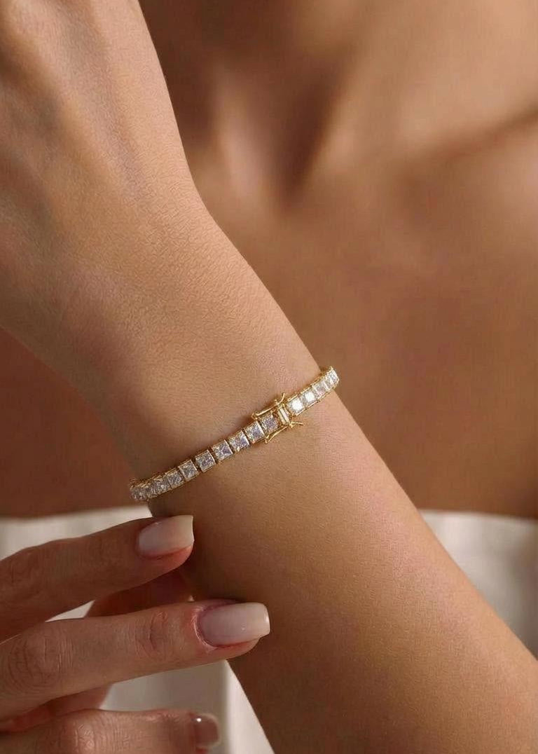 Silver toned tennis bracelet, worn on wrist for size and fit reference