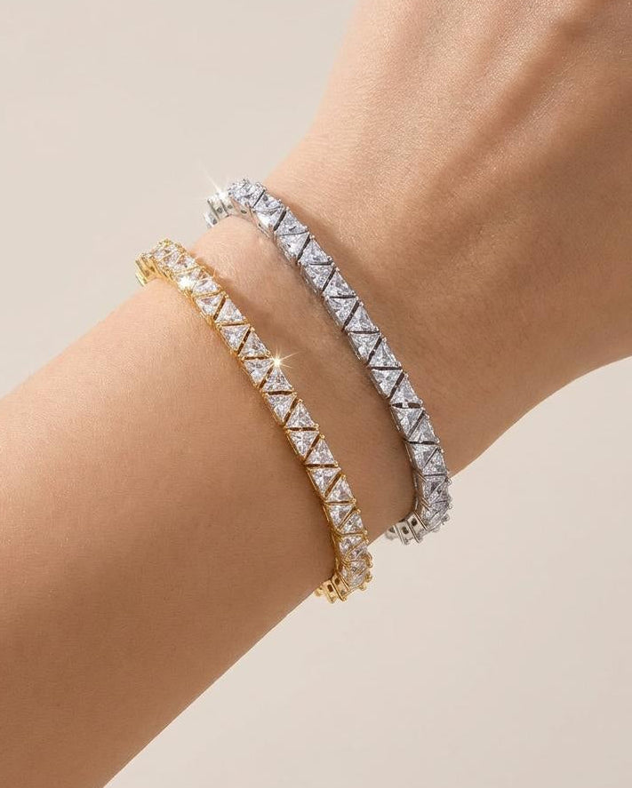 Gold and rhodium geometric tennis bracelets worn stacked 