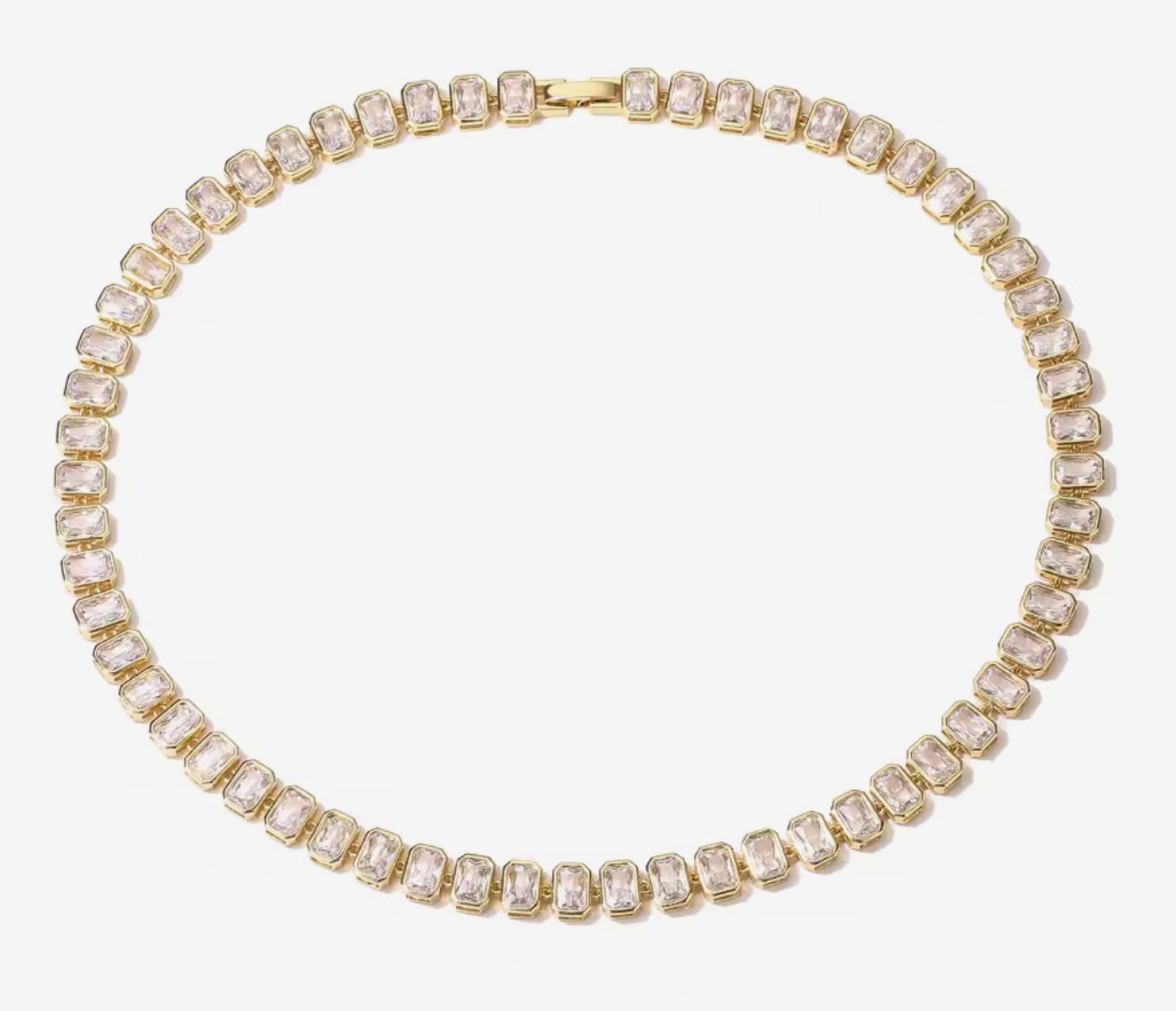 Gold tennis necklace with clear gemstones on a white background