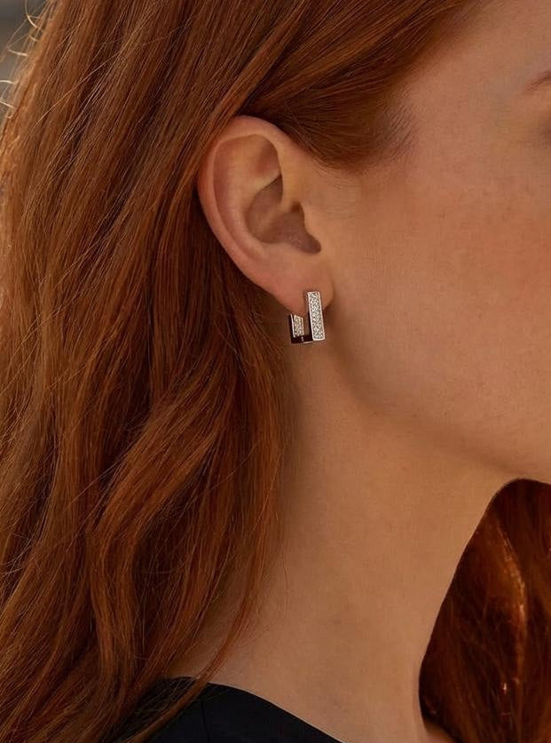 Square gold huggie hoop earrings with cubic zirconia worn on model, minimalist everyday style