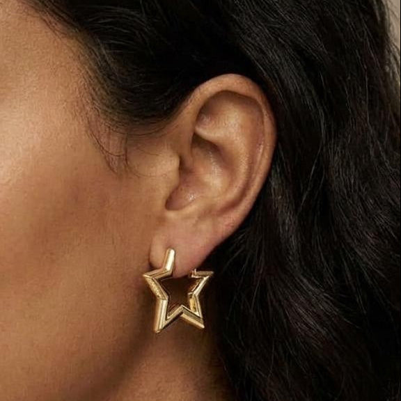 Model wearing medium-size 14K gold plated hoop earrings with polished finish
