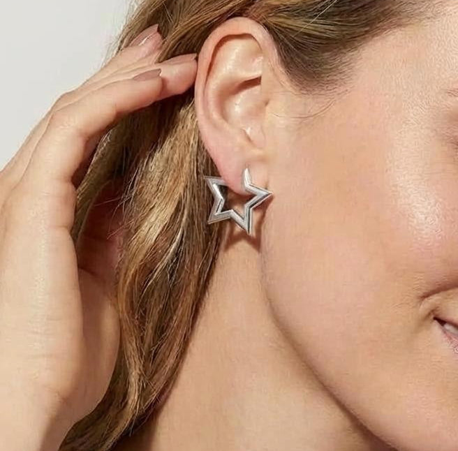 Model wearing medium-size 14K white gold plated hoop earrings with polished finish