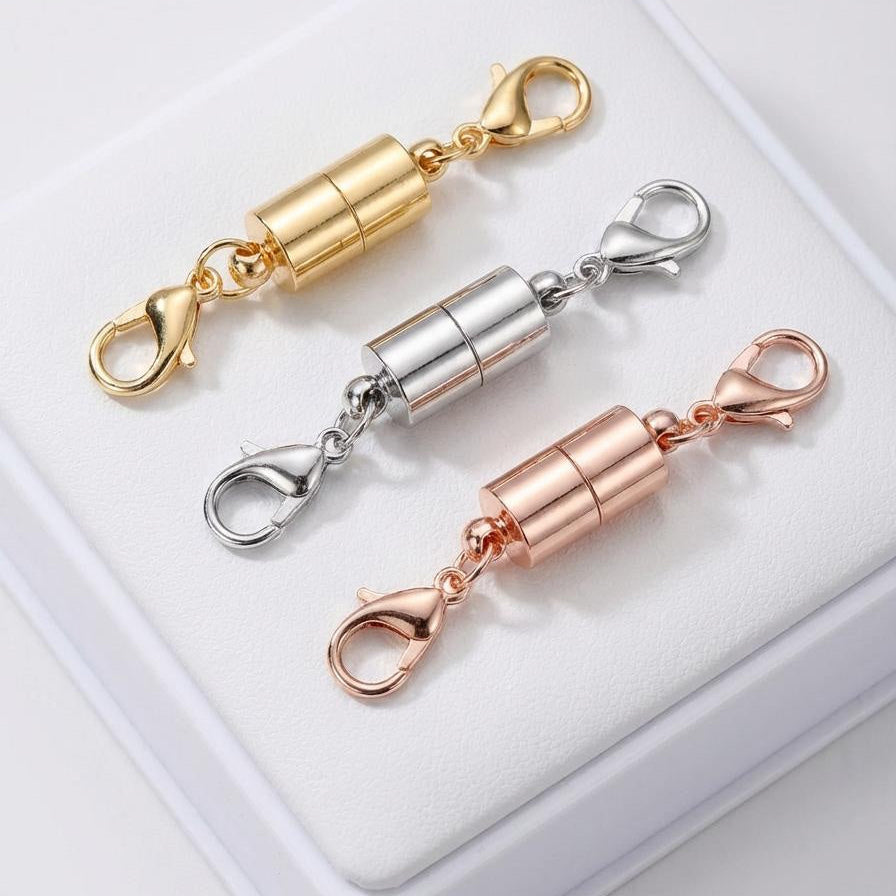 Three magnetic chain extenders in gold, silver, and rose gold on a white background.