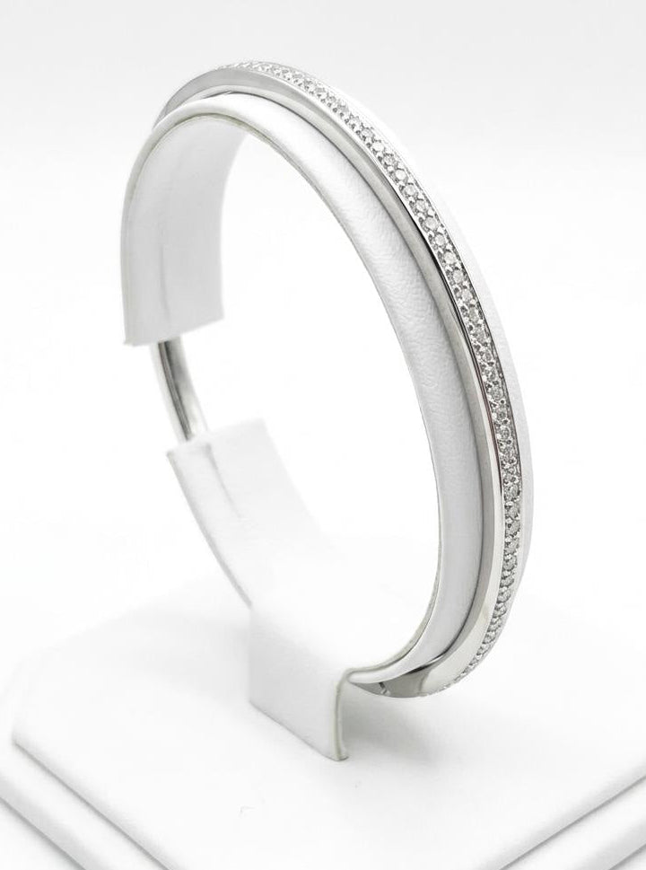 Silver bracelet on a white stand with a white background