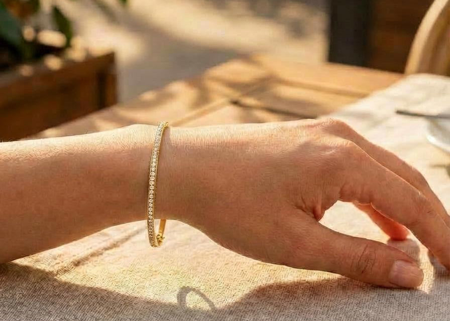 Hand with a Gold tennis bangle bracelet