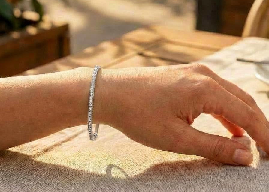 Hand wearing silver tennis bangle bracelet