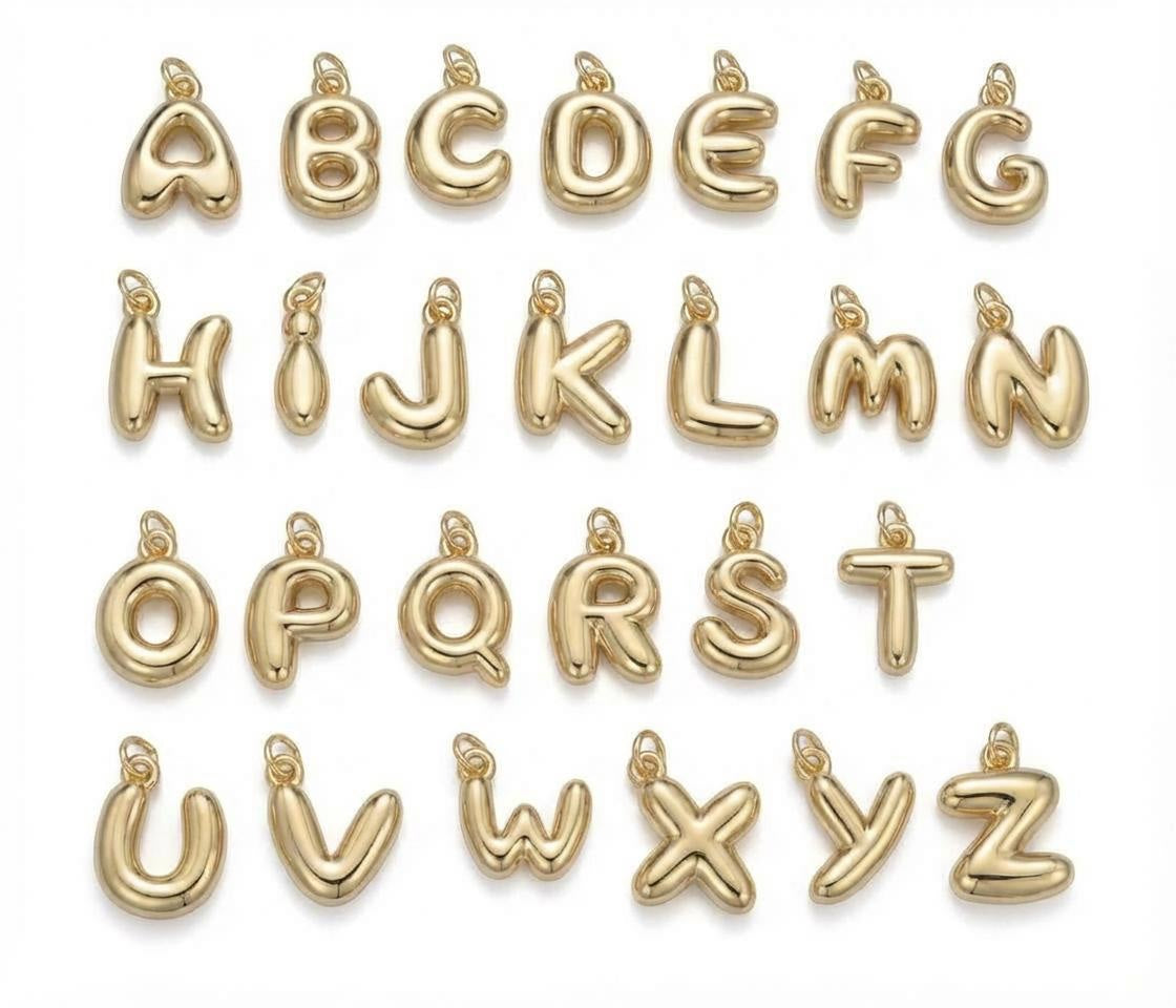 Gold letter pendants from A to Z on a white background