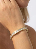 Model wearing a gold-plated enamel tile bracelet with clear crystal accents