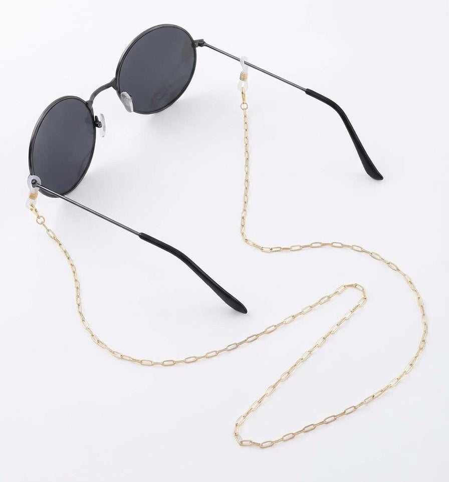 Sunglasses with a gold chain on a white background