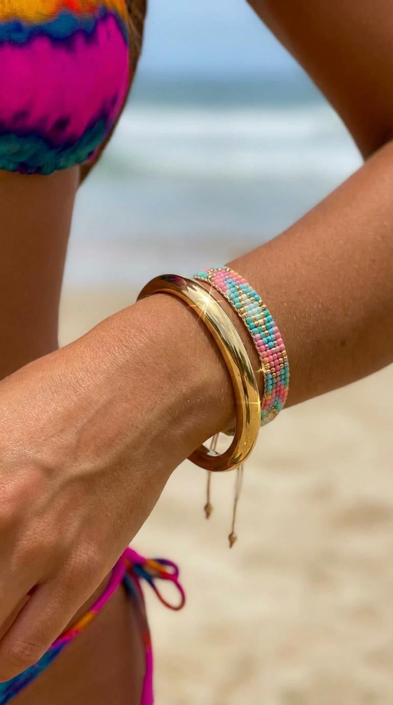 Close up of model wearing gold bangle 