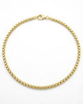 Gold chain ankle bracelet on a white background
