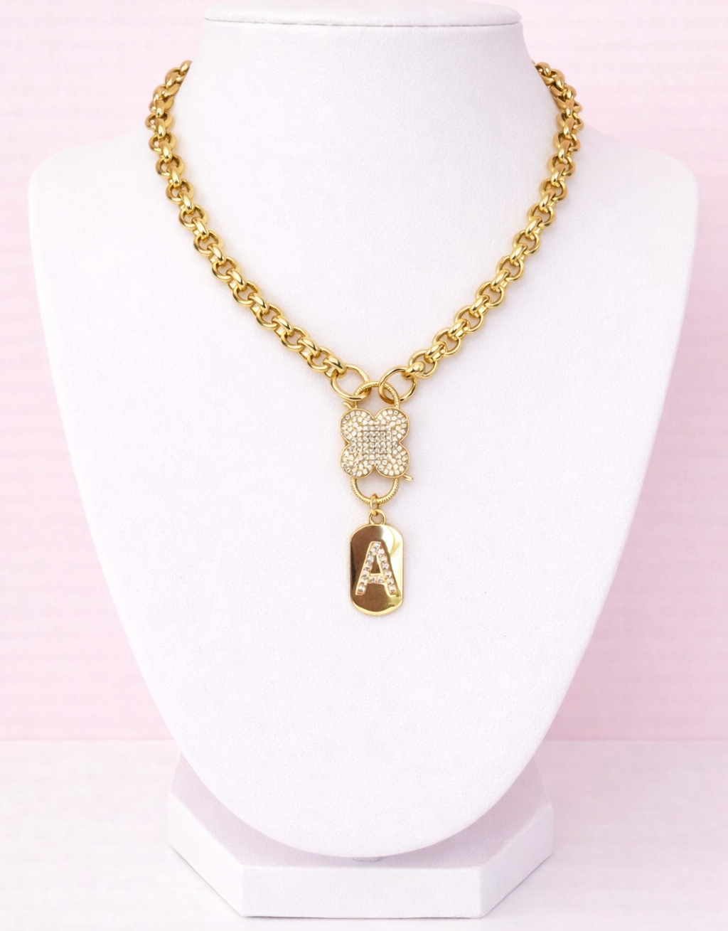 Gold clover charm necklace with cubic zirconia stones on stainless steel chain