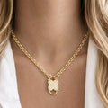 Gold clover charm necklace with cubic zirconia stones on stainless steel chain worn by model, Haus of Sugar boutique jewelry