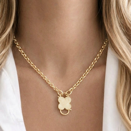Gold clover charm necklace with cubic zirconia stones on stainless steel chain worn by model, Haus of Sugar boutique jewelry