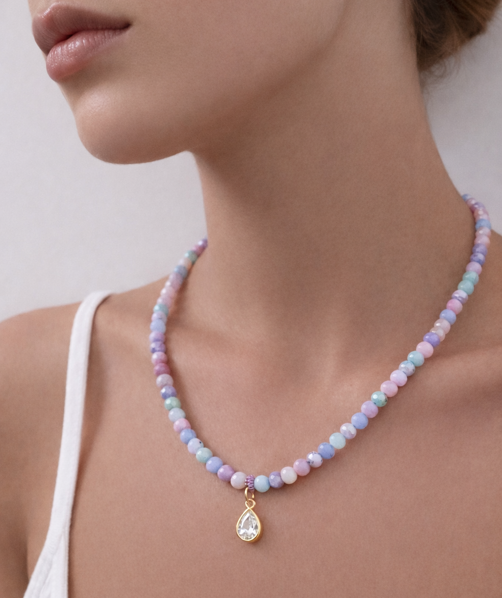 Iridescent crystal bead necklace with gold teardrop charm worn on model, colourful glass bead necklace from Haus of Sugar Jewellery