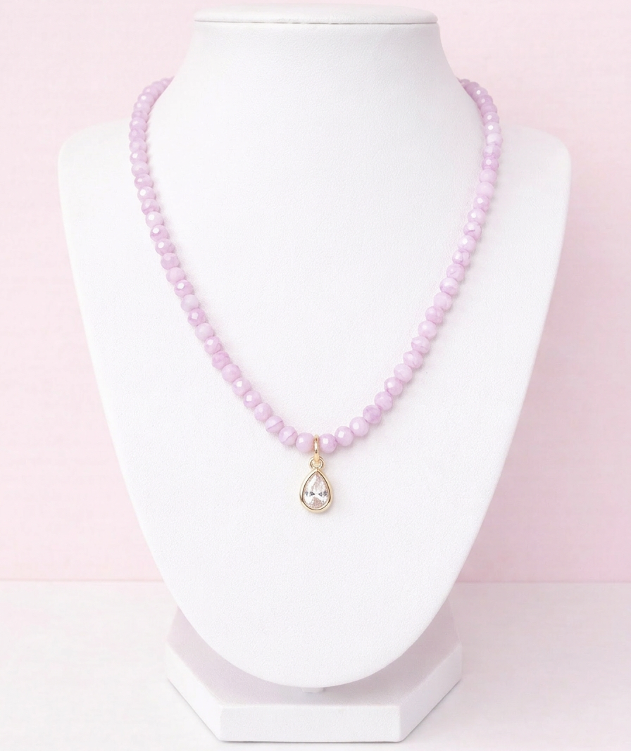Iridescent purple glass bead necklace with gold teardrop crystal pendant on delicate chain