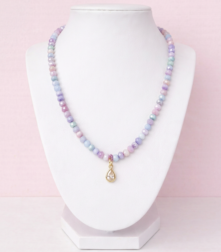 Iridescent purple glass bead necklace with gold teardrop crystal pendant on delicate chain
